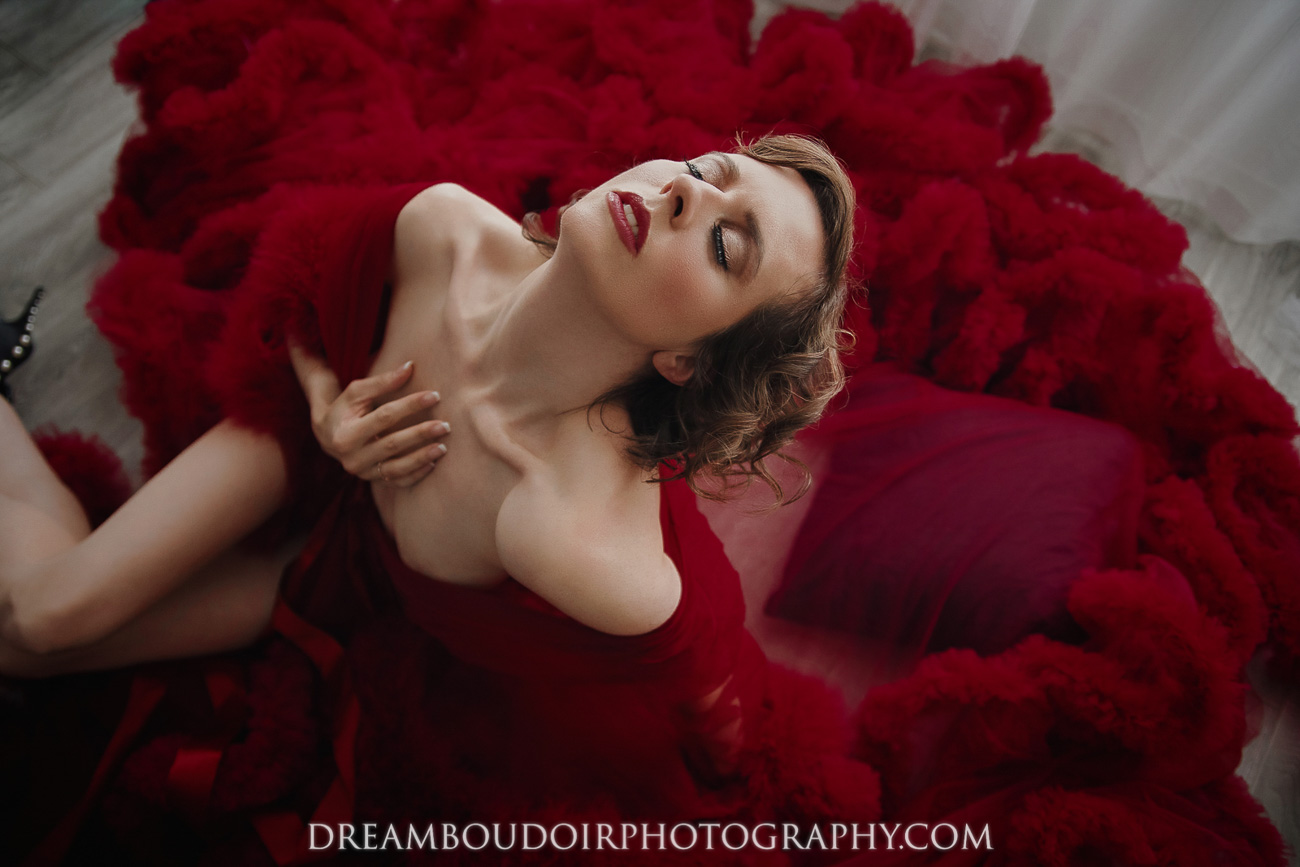Beautiful Confident Women in a Long Red Dress Posing for Dream Boudoir Shoot